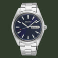 A Seiko stainless steel wristwatch with a dark blue dial, silver-tone metal case and bracelet, silver-tone hour markers, and a day/date window at 3 o'clock.