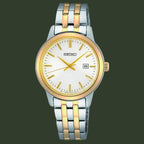 A Seiko women's analog watch with a silver and gold-tone two-tone stainless steel link bracelet, a gold-tone bezel, and a white dial with gold hands and hour markers.