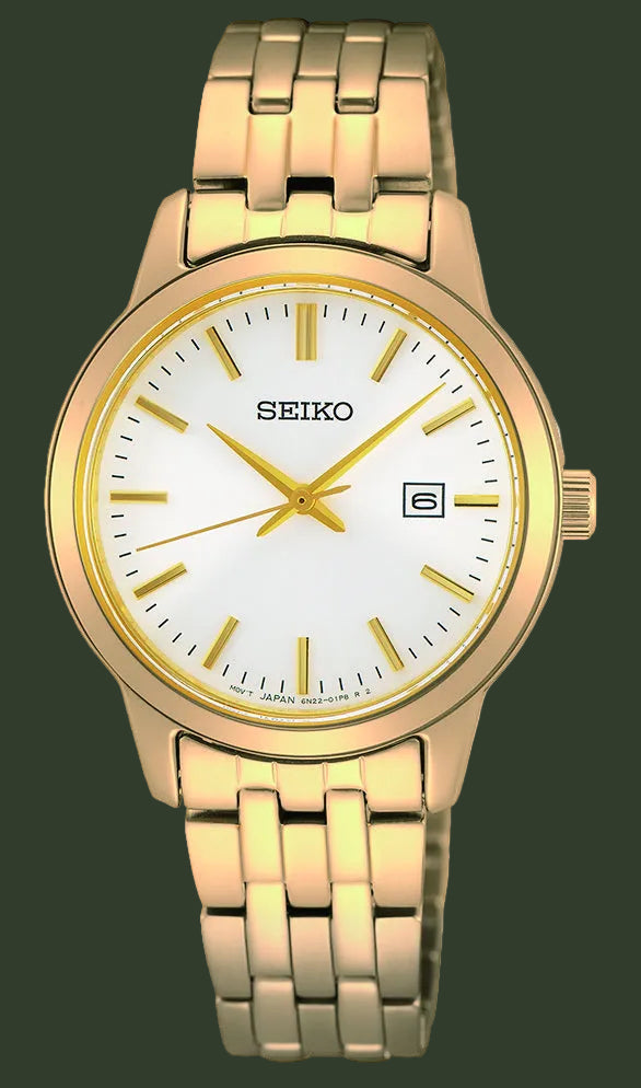 A Seiko analog watch with a gold-tone metal link bracelet, a gold bezel, and a white dial with gold hands and hour markers.