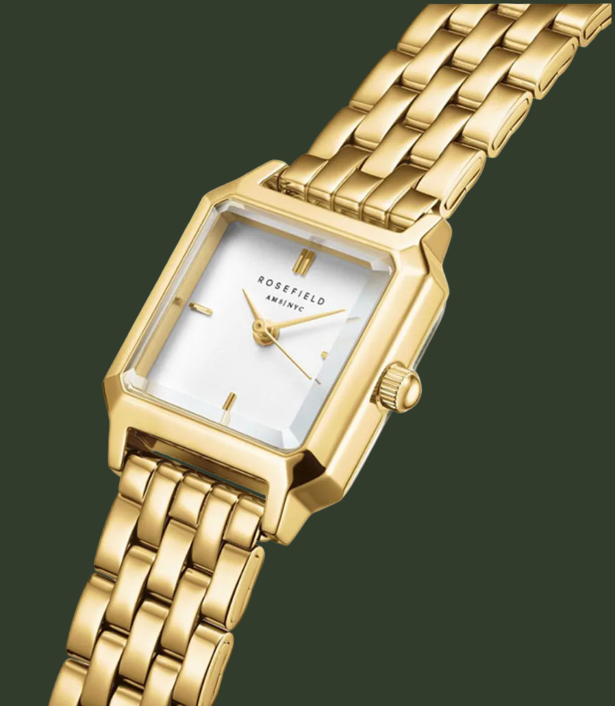 Rosefield Infinity women's watch featuring a gold-tone rectangular case, white dial with gold-tone hands and hour markers, and a matching gold-tone link bracelet, shown on a plain white background.