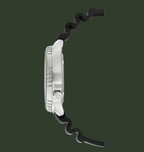 A close-up side view of a watch with a silver-toned metal case and a black wavy silicone strap, shown on a plain white background.