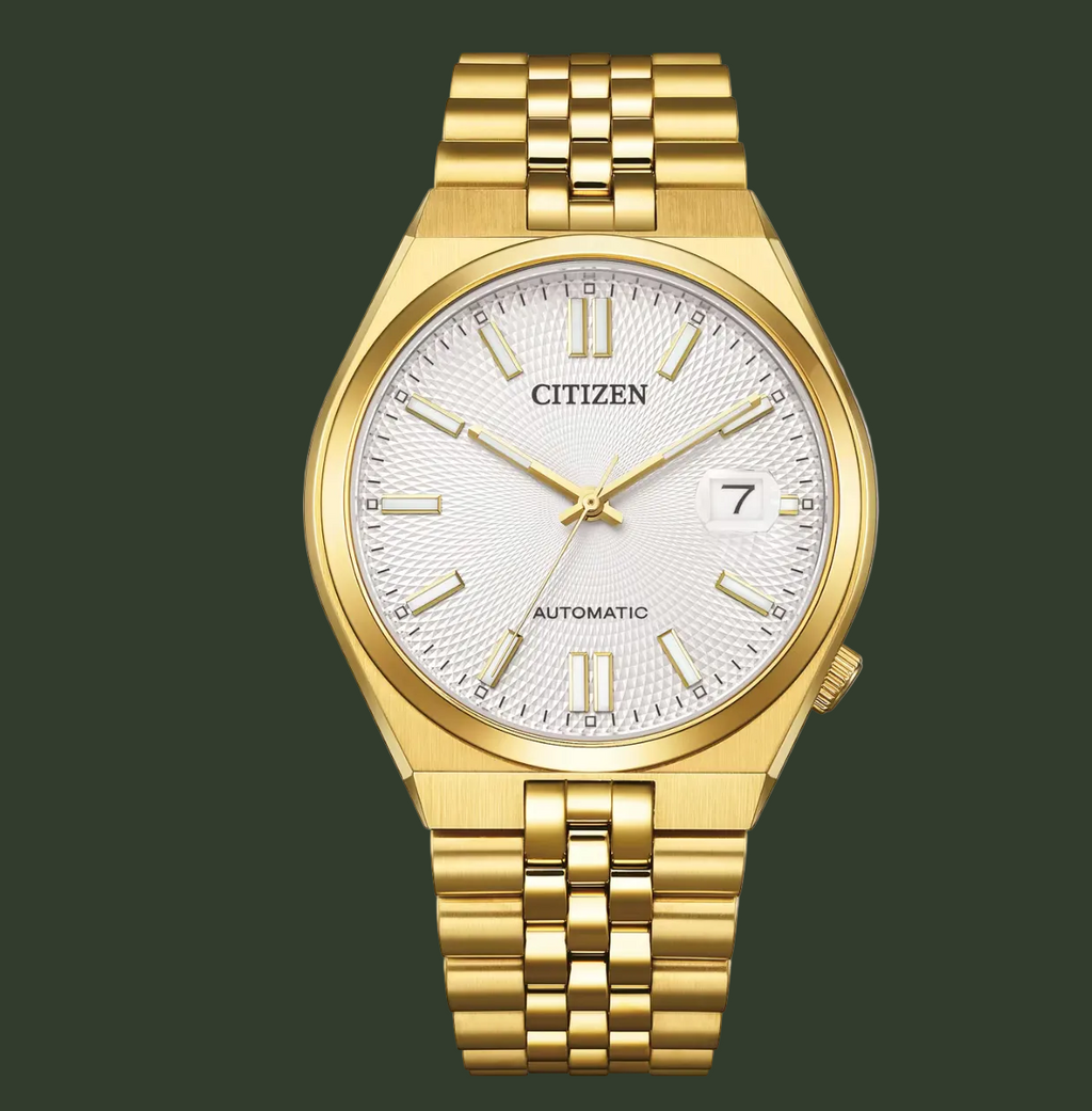 Citizen Gold Automatic watch with a gold-tone metal case and link bracelet, featuring a textured white dial with gold-tone indices and hands.