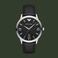 Black watch with silver bezel and black leather strap on a light gray background