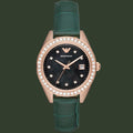 Watch with green strap and rose gold case on white background