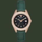 Watch with green strap and rose gold case on white background
