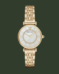 Gold watch with a white face on a white background