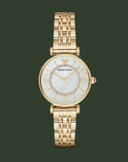 Gold watch with a white face on a white background