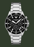 An Emporio Armani 100m/200m Solar chronograph watch with a black dial, black bezel, and a silver stainless steel link bracelet, shown against a plain white background.