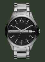 Armani Exchange men's analog watch with a silver stainless steel case and link bracelet, featuring a black textured dial with silver-tone hands, white hour markers, and a date window showing '21'.
