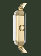 A close-up side profile of a gold-tone watch with a rectangular face and a matching gold-tone strap, shown against a plain white background.