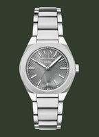 An analog wristwatch with a silver stainless steel case and integrated metal link bracelet, featuring a textured sunburst dial with silver-tone hands and markers.