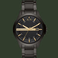 Black Armani Exchange watch with gold accents on a white background