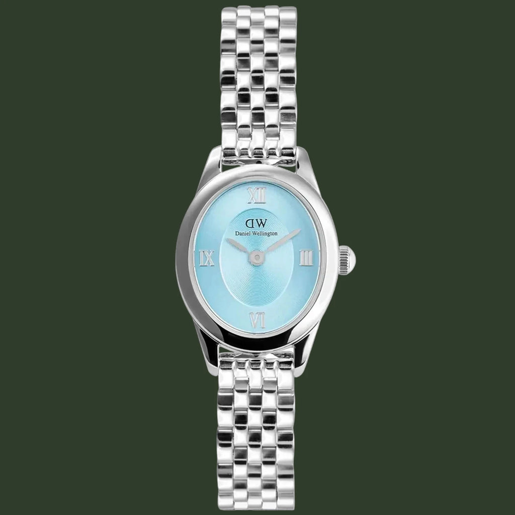 A silver-tone metal wristwatch with a round light blue dial, Roman numeral hour markers, and a matching silver link bracelet, shown against a plain white background.