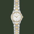 An Armani Exchange women's two-tone watch with a silver and gold-tone metal link bracelet, a white dial with mother-of-pearl texture, and a bezel set with small clear crystals.