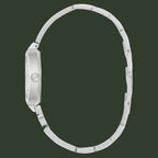 Silver stainless steel women's watch shown from the side profile, featuring a matching metal link bracelet and a round bezel, set against a plain white background.