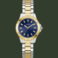 Two-tone gold and silver watch with a blue dial on a white background