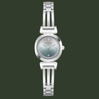 A women's GUESS wristwatch with a silver-toned metal link bracelet, a round bezel, and a silver dial accented with a ring of small clear crystals around the hour markers.