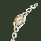 A two-tone Guess women's watch featuring a silver and gold-tone link bracelet, a silver and gold-tone oval case, and a white dial with a bezel set with small clear crystals.
