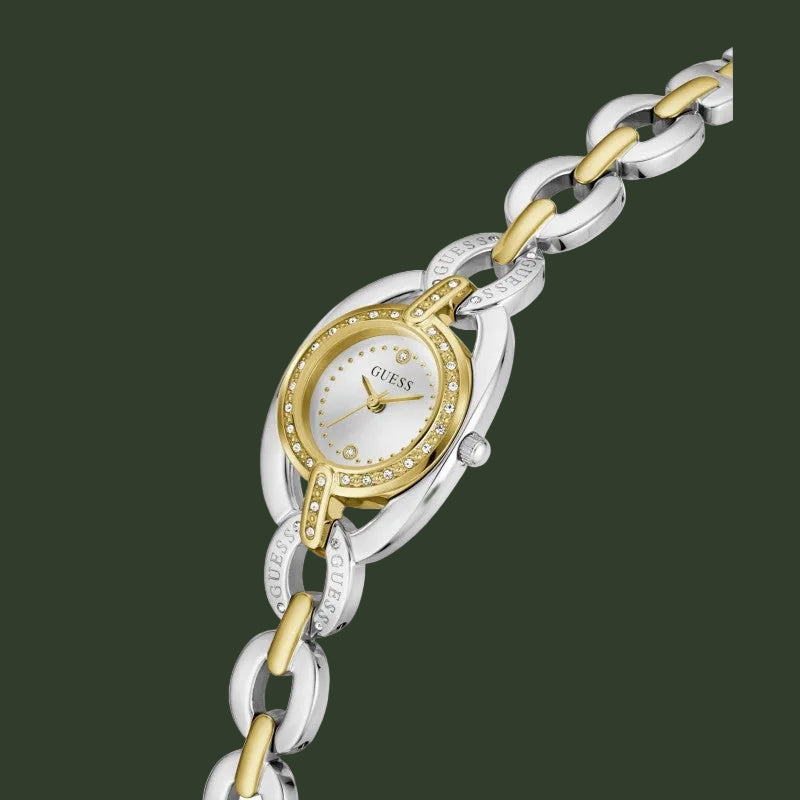 A two-tone Guess women's watch featuring a silver and gold-tone link bracelet, a silver and gold-tone oval case, and a white dial with a bezel set with small clear crystals.