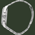 Close-up of a silver watch with a detailed bezel on a white background