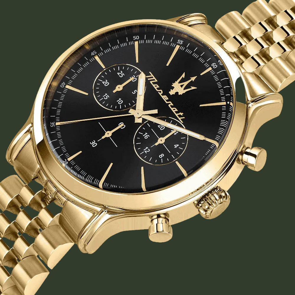 Gold watch with black face on a white background