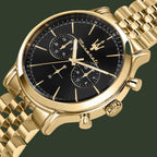 Gold watch with black face on a white background