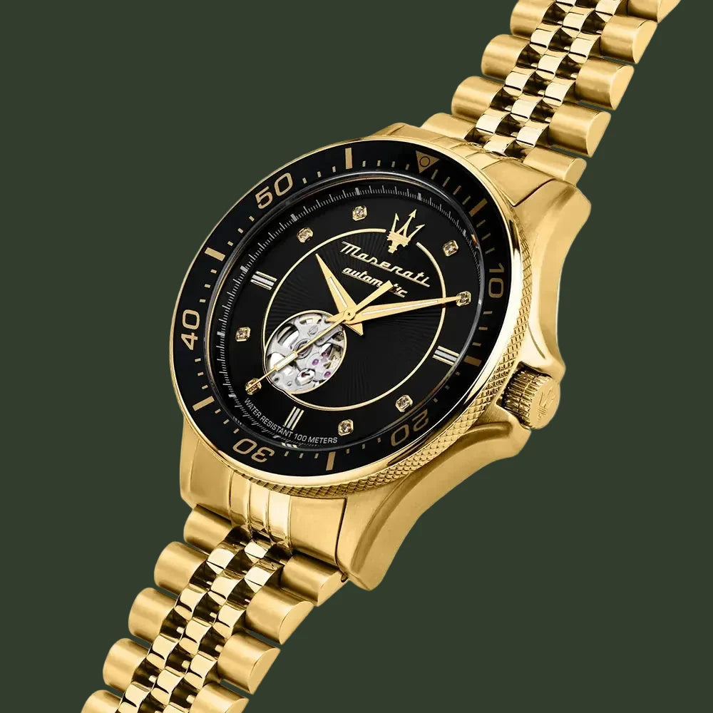 Gold watch with black face on a white background