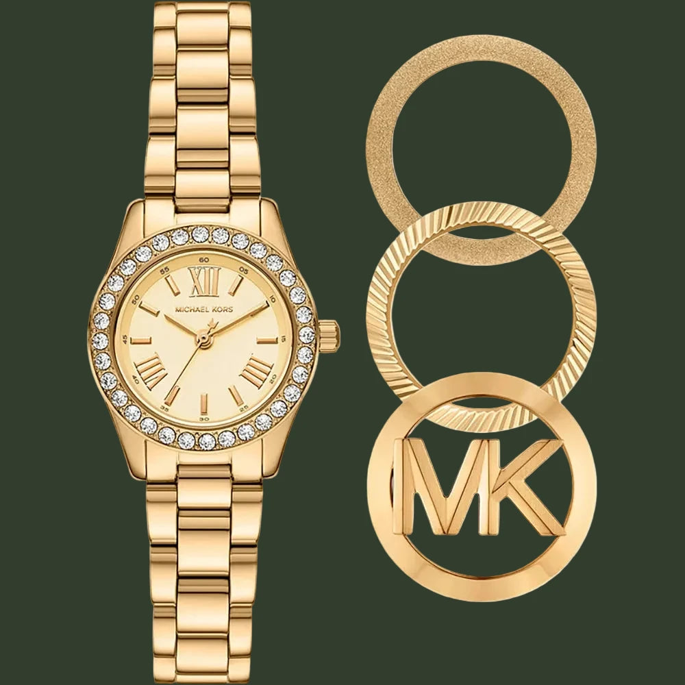 Gold-tone Michael Kors watch with a crystal-studded bezel and matching metal bracelet, shown beside three circular gold ring charms featuring the MK logo.