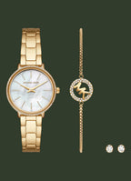 Michael Kors jewelry set featuring a gold-tone stainless steel watch with a mother-of-pearl dial, a matching gold-tone bracelet with a crystal-accented MK logo charm, and a pair of matching stud earrings, all on a white background.