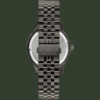 Rear view of a Maserati watch with a dark gunmetal metallic link bracelet and a silver-toned case back, shown on a plain white background.
