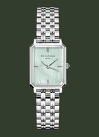 Silver watch with a light green face on a white background