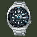 A Seiko Padi Automatic Diver's 200m watch with a silver stainless steel case and bracelet, featuring a black dial with white and blue accents, a black rotating bezel, and a day and date window.