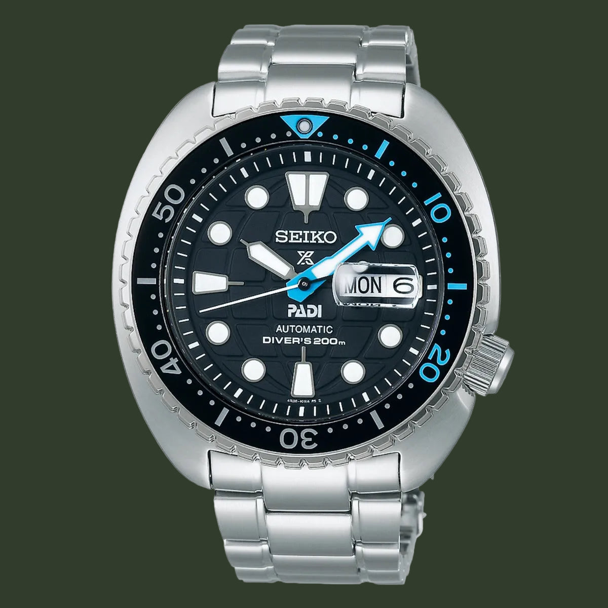 A Seiko Padi Automatic Diver's 200m watch with a silver stainless steel case and bracelet, featuring a black dial with white and blue accents, a black rotating bezel, and a day and date window.