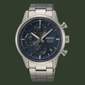 A Seiko chronograph watch with a silver stainless steel case and link bracelet, featuring a dark blue dial with three subdials and silver-tone hands and markers.