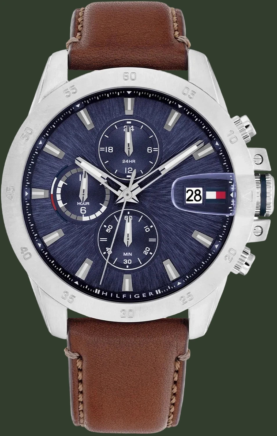 A Tommy Hilfiger men's chronograph watch featuring a silver-tone stainless steel case, a dark blue textured dial with three subdials, a date window with the Tommy Hilfiger flag, and a brown leather strap.