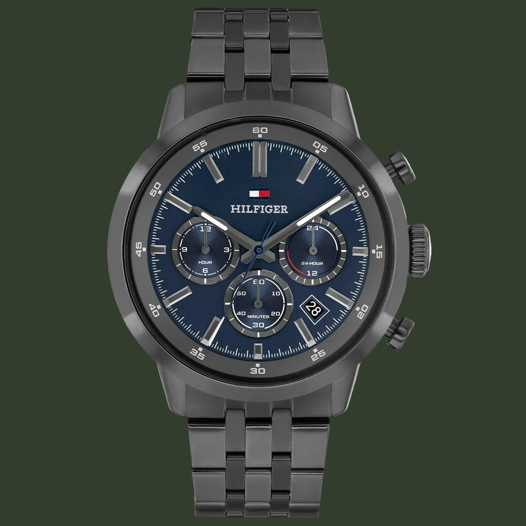 Tommy Hilfiger watch with dark blue face and black metal strap on a white background