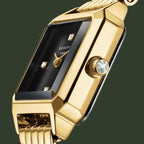 Gold wristwatch with a black face on a white background