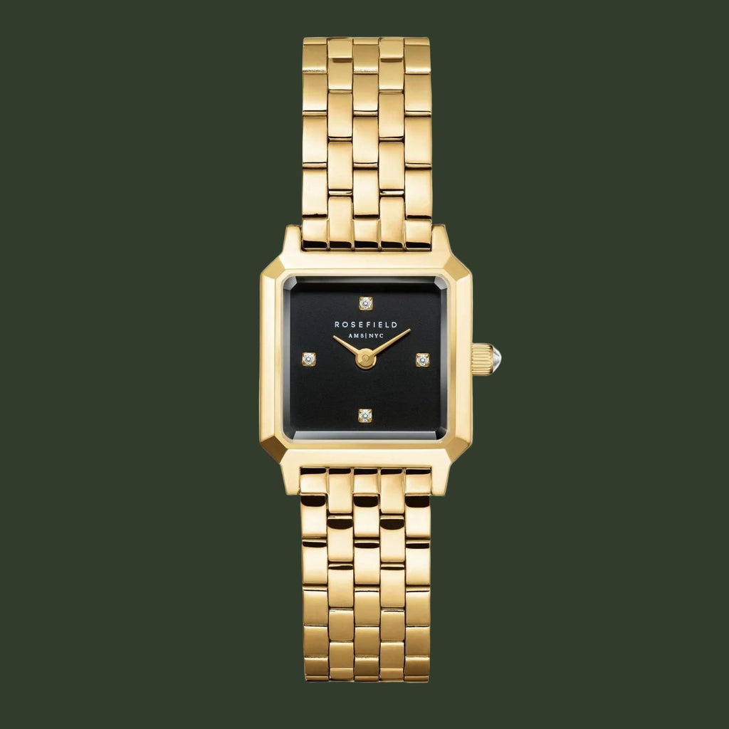 A gold-tone metal watch with a rectangular black dial and a matching gold-tone link bracelet, shown against a plain white background.