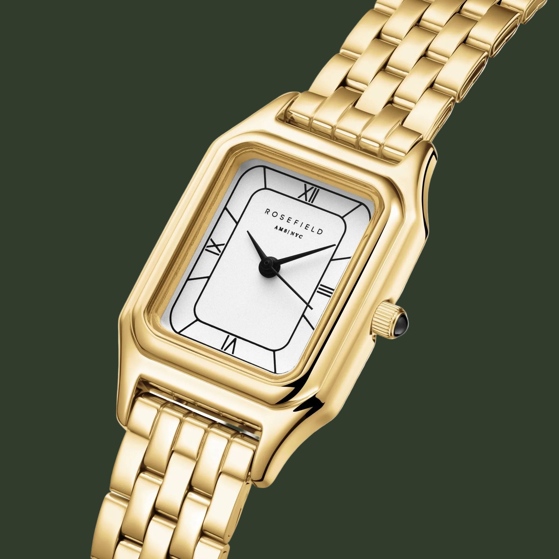 A gold-tone rectangular analog watch with a white dial, black hands, Roman numeral hour markers, and a matching gold-tone metal link bracelet, shown on a plain white background.