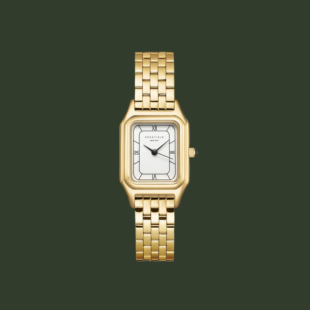 A gold-tone rectangular analog watch with a white dial and black Roman numeral hour markers, presented on a solid white background.