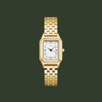 A gold-tone rectangular analog watch with a white dial and black Roman numeral hour markers, presented on a solid white background.