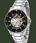 A Maserati automatic watch with a silver stainless steel link bracelet, a black dial, and gold-tone details, shown on a white background.